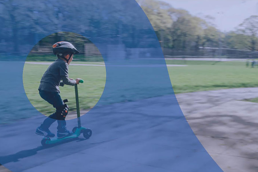 Photo of boy riding a scooter